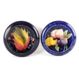 TWO MOORCROFT SHALLOW SMALL DISHES WITH CURVED RIMS decorated in the Leaf and Berry and Plum pattern