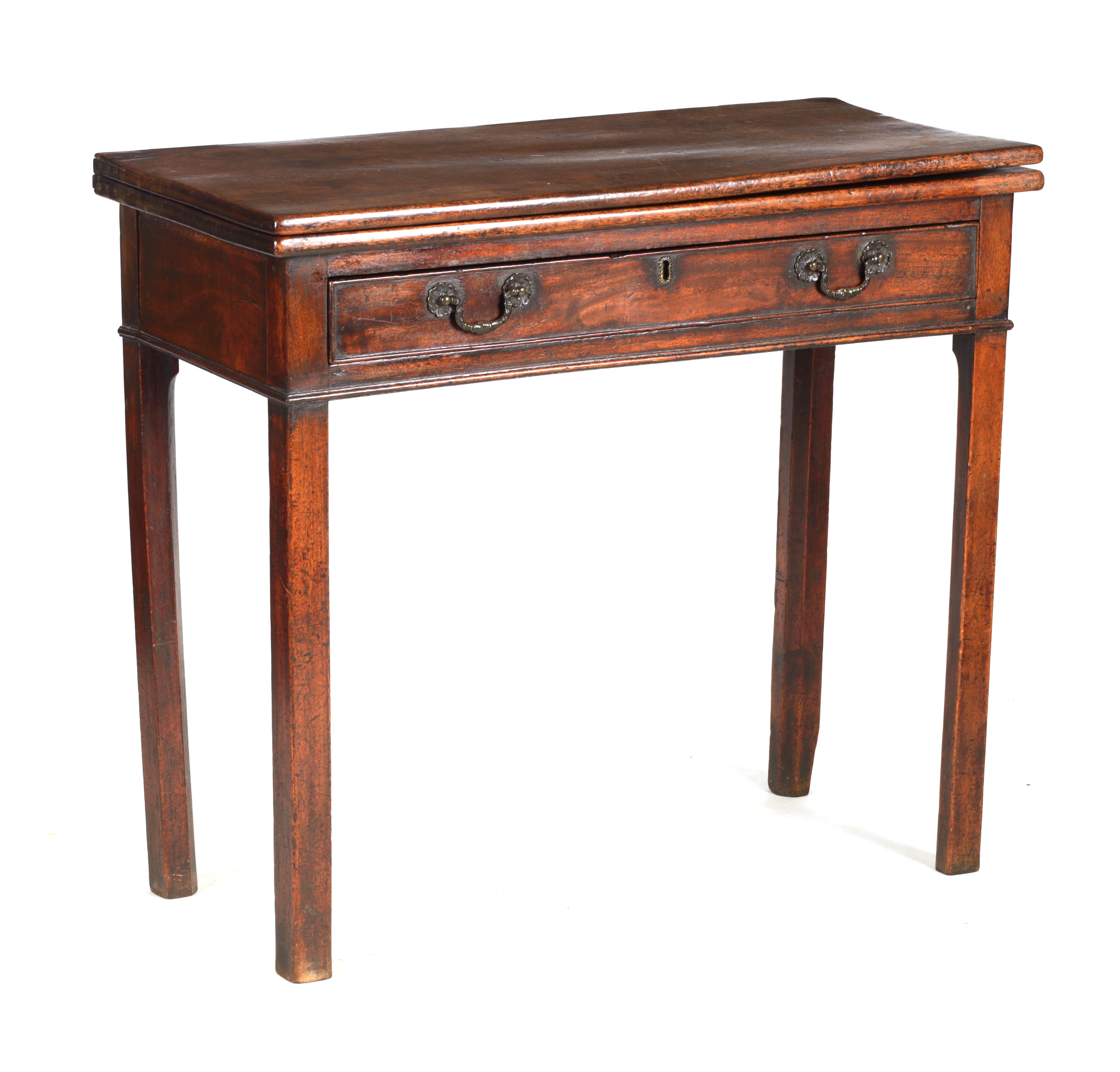 A GEORGE III MAHOGANY TEA TABLE with fold over top above a frieze drawer; standing on square