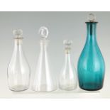 A SELECTION OF FOUR GEORGIAN GLASS DECANTERS of tapering form with stoppers, three clear glass one