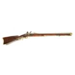 AN 18TH CENTURY FLINTLOCK RIFLE having an octagonal rifled barrel with brass sight, bevelled lock,