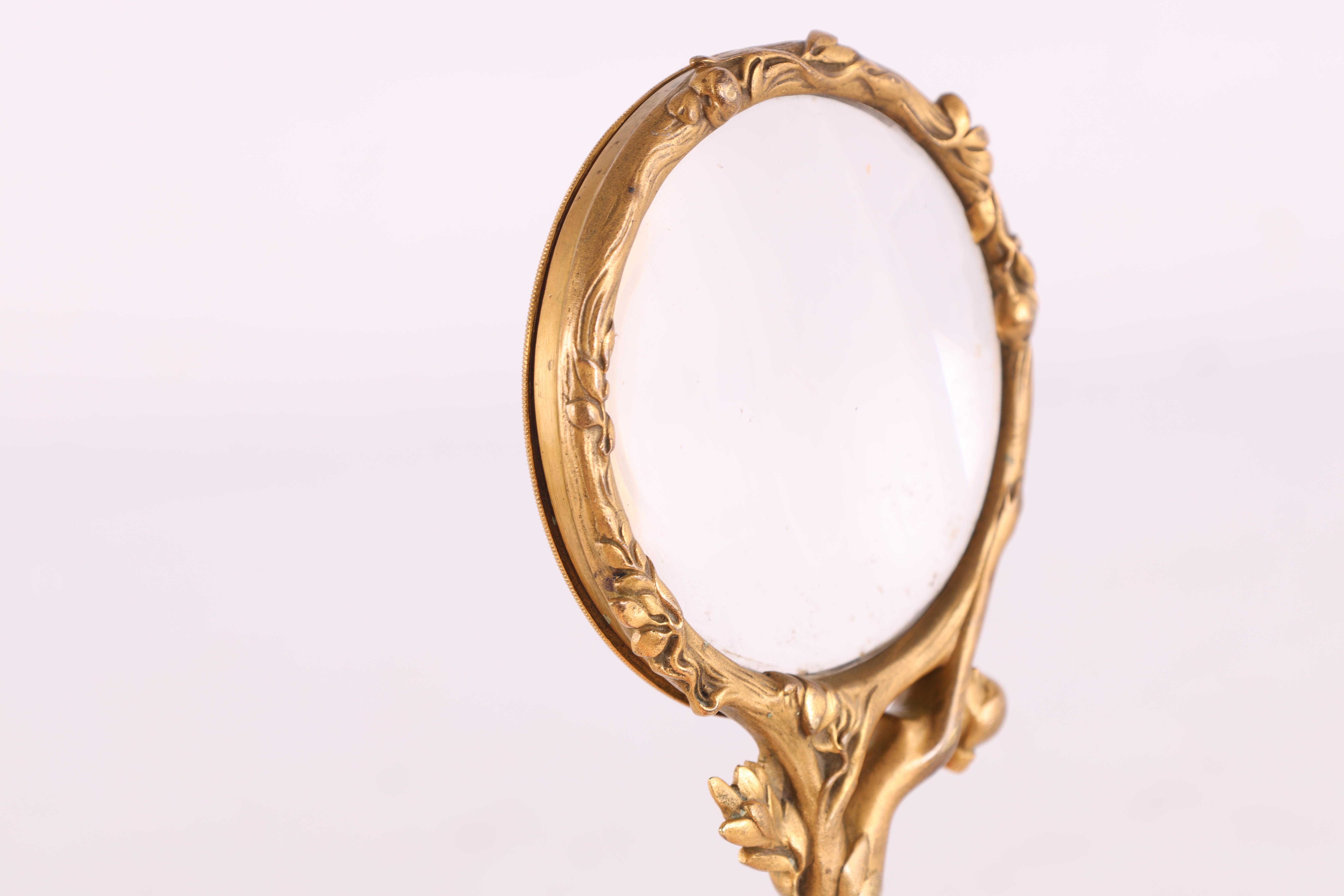 A FRENCH GILT BRONZE ART NOUVEAU MAGNIFYING GLASS the handle decorated with a stylized nude female - Image 3 of 4