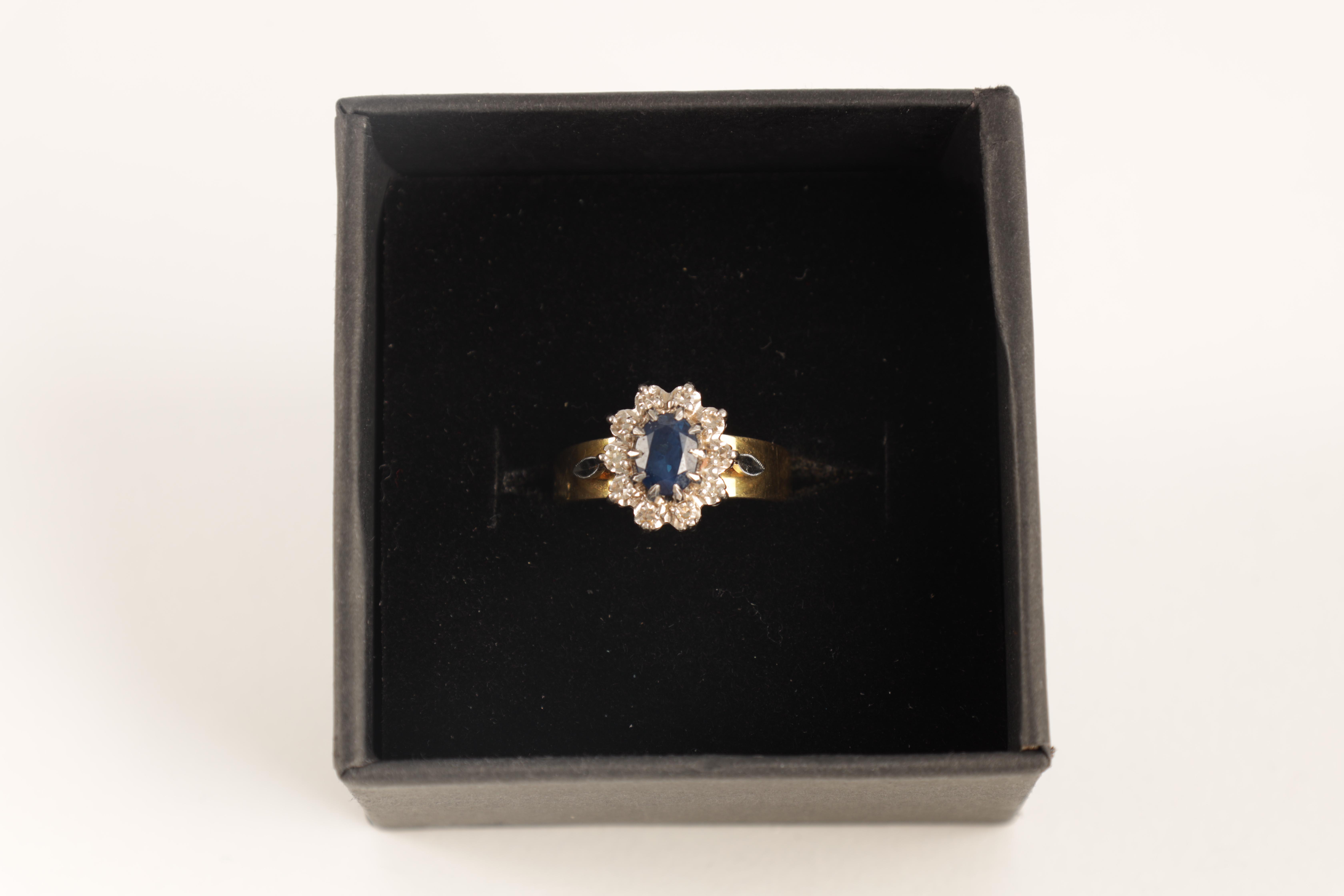 A LADIES 14CT GOLD DIAMOND AND SAPPHIRE RING with oval cut centre stone enclosed by 10 brilliant-cut - Image 2 of 6