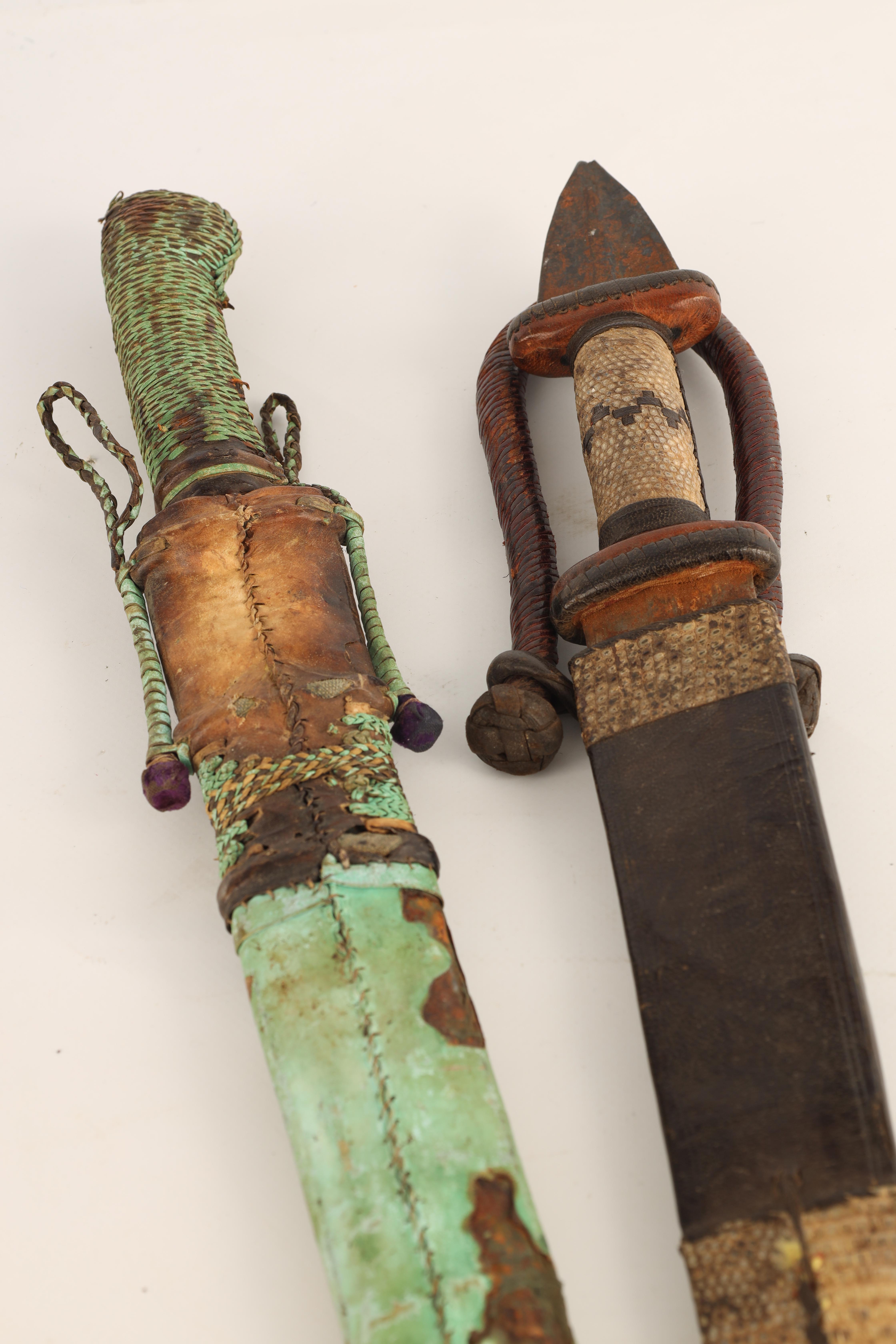 TWO 19TH CENTURY AFRICAN DAGGERS one with a snakeskin handle and scabbard having a tapering steel - Image 2 of 7