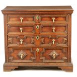 A WILLIAM AND MARY OAK GEOMETRIC MOULDED CHEST OF DRAWERS OF SMALL SIZE with plank top above a