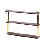 A SET OF 19TH CENTURY MAHOGANY THREE TIER HANGING SHELVES joined by brass mounts with turned