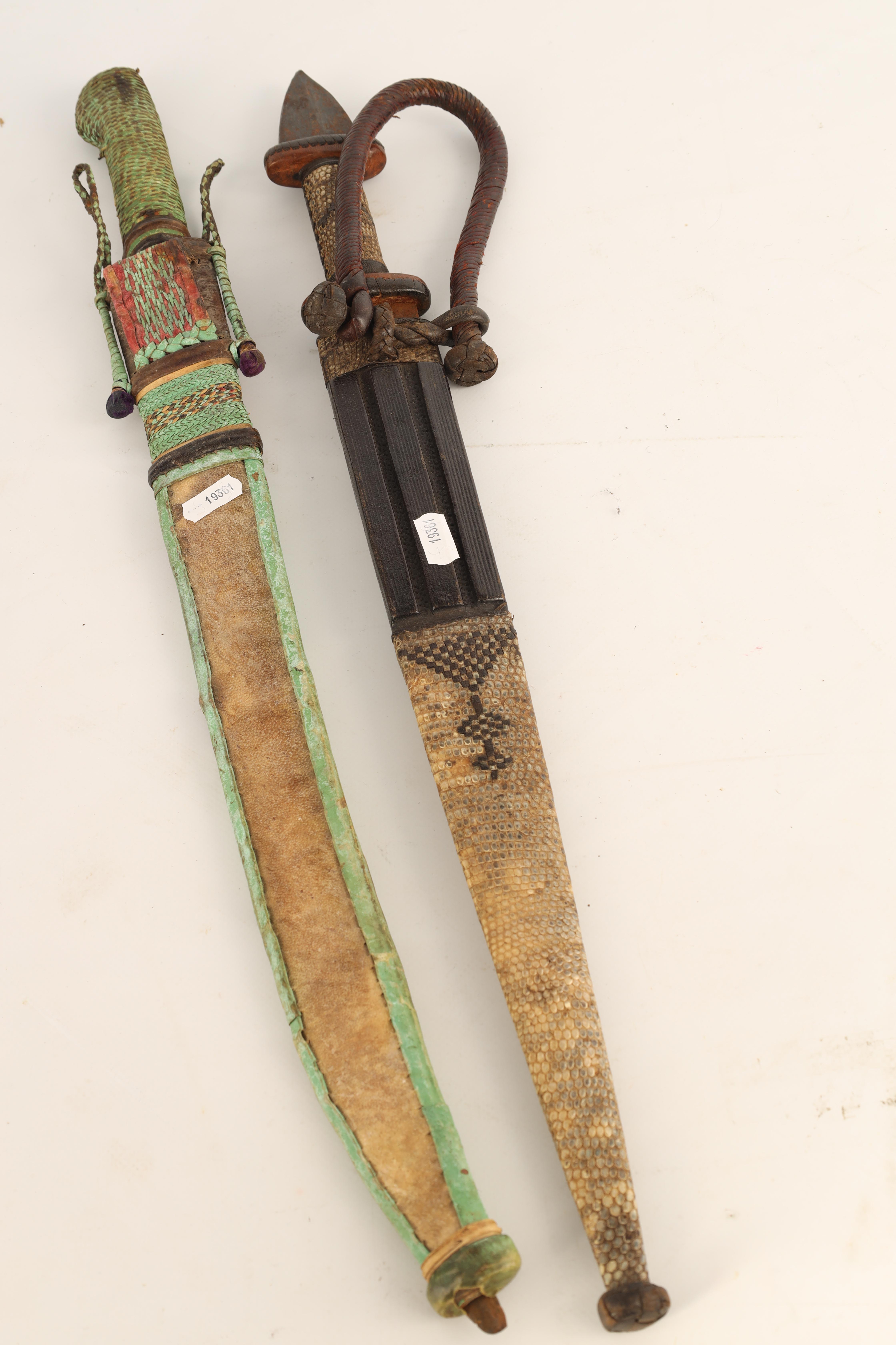 TWO 19TH CENTURY AFRICAN DAGGERS one with a snakeskin handle and scabbard having a tapering steel - Image 4 of 7