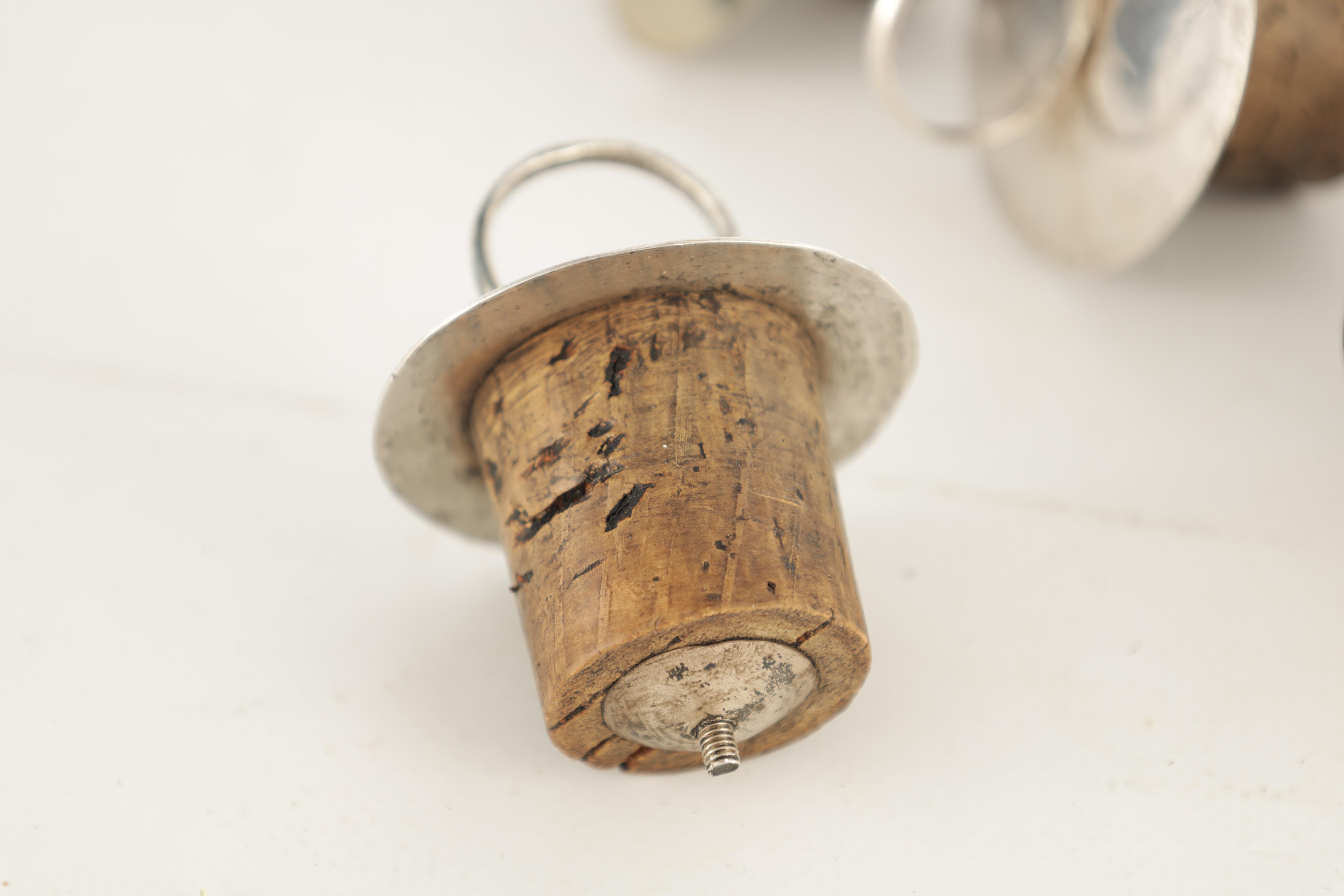 A COLLECTION OF 9 SILVER TOPPED DECANTER STOPPERS with ringed circular tops - Image 2 of 2