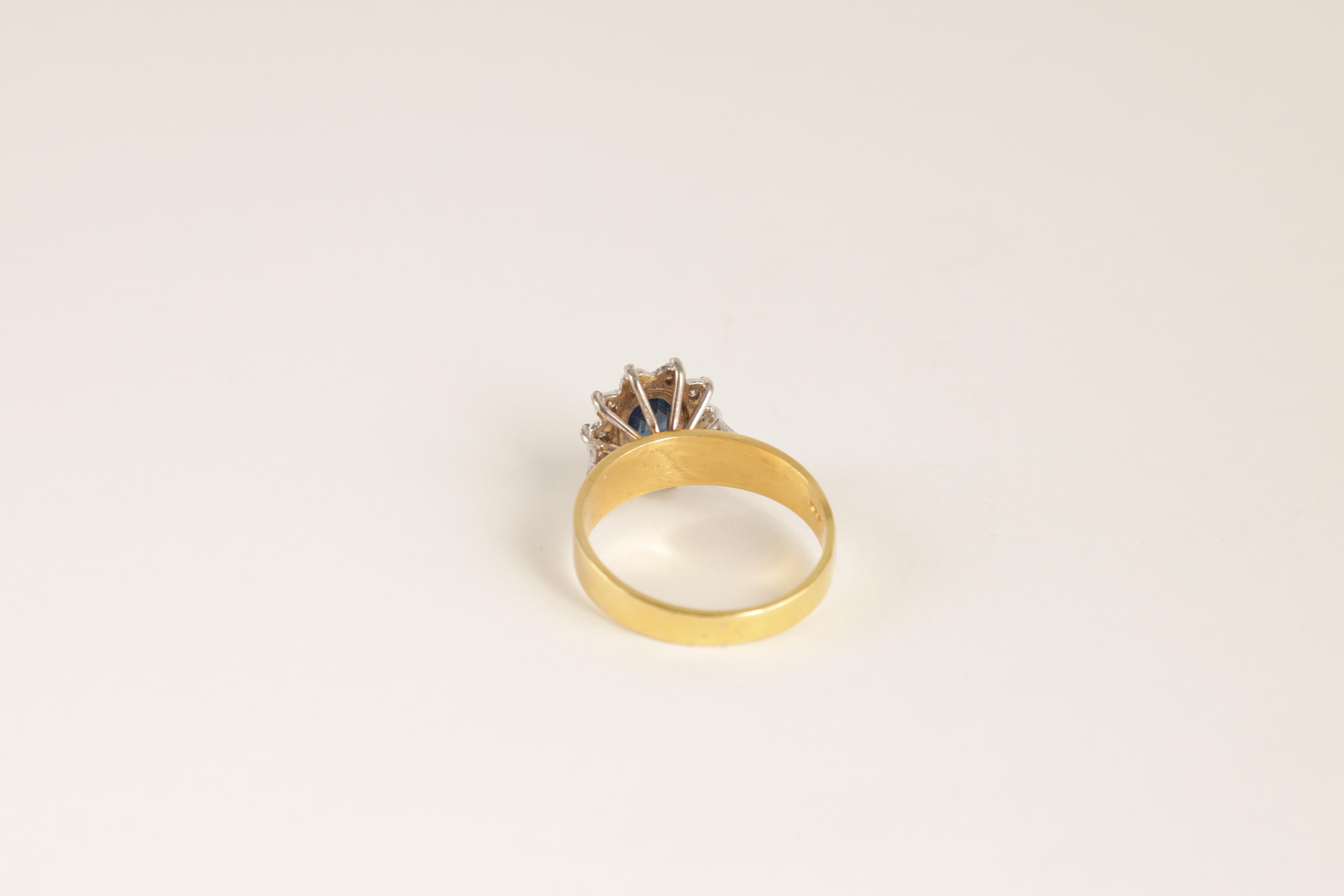 A LADIES 14CT GOLD DIAMOND AND SAPPHIRE RING with oval cut centre stone enclosed by 10 brilliant-cut - Image 6 of 6