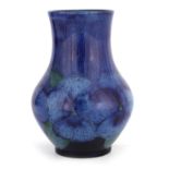 AN UNUSUAL MOORCROFT SMALL BULBOUS VASE decorated with a band of blue Pansies on a shaded speckled