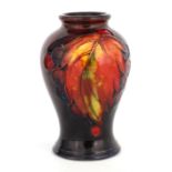 A 1930S MOORCROFT SMALL INVERTED BALUSTER VASE decorated in the Autumn Leaf and Berry pattern on a