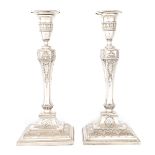 A PAIR OF 19TH CENTURY SHEFFIELD PLATE SILVER ON COPPER ADAM STYLE CANDLESTICKS bearing the crest