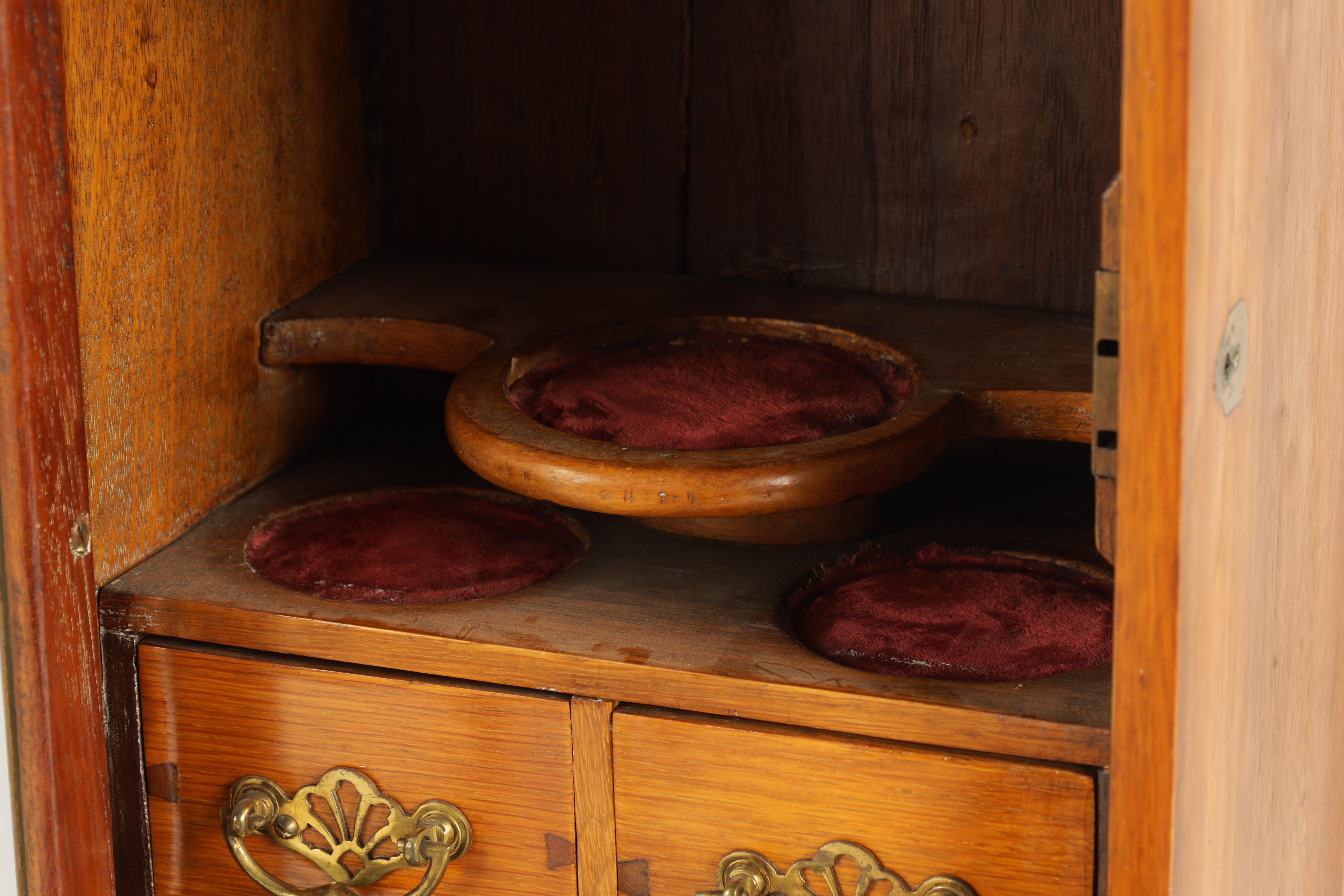 A STYLISH EDWARDIAN OAK SMOKERS CABINET with glazed door enclosing a shelved three drawer interior - Image 10 of 11