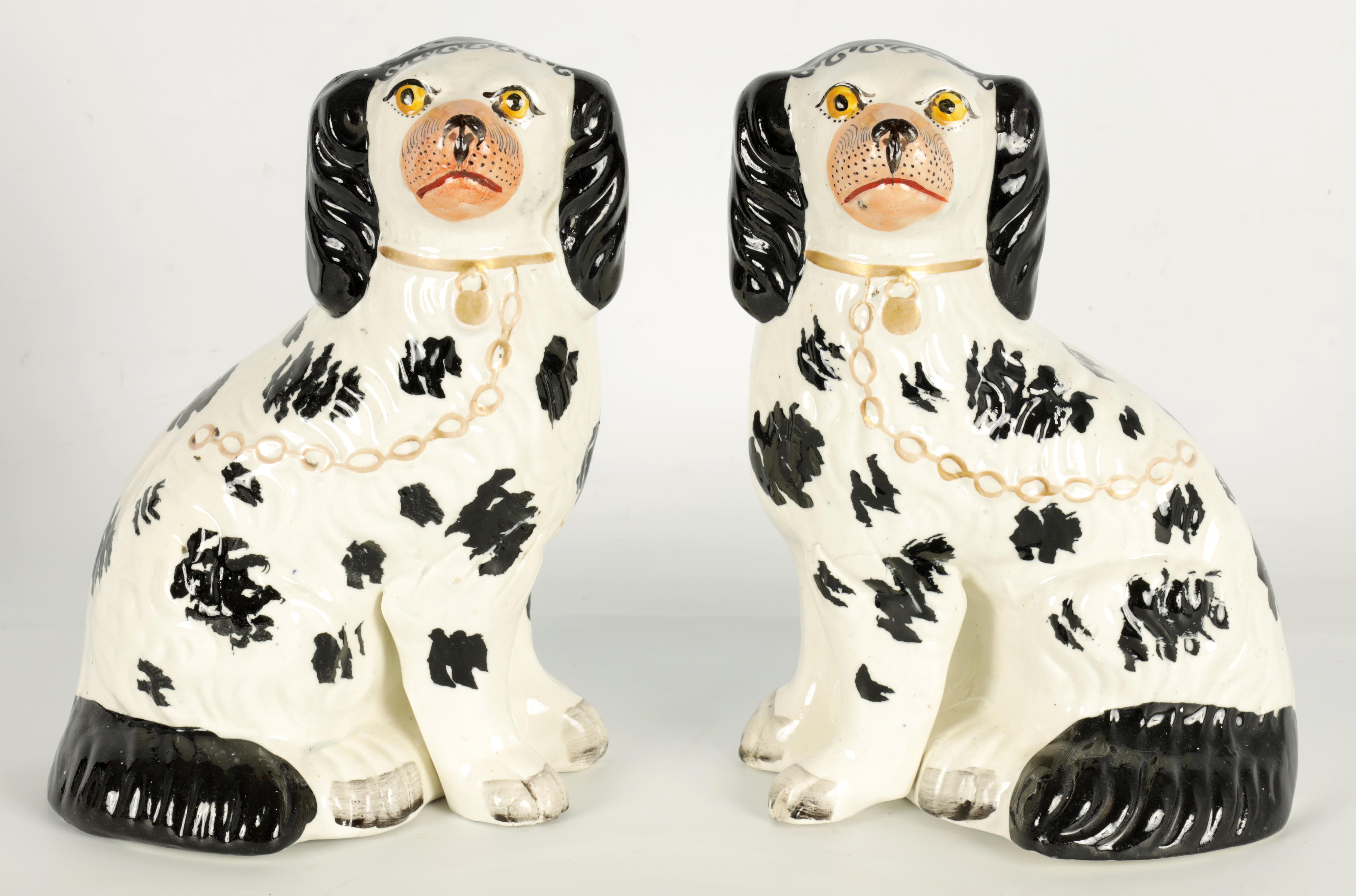 A PAIR OF 19TH CENTURY STAFFORDSHIRE ‘DISRAELI CURL’ SPANIELS 23cm high