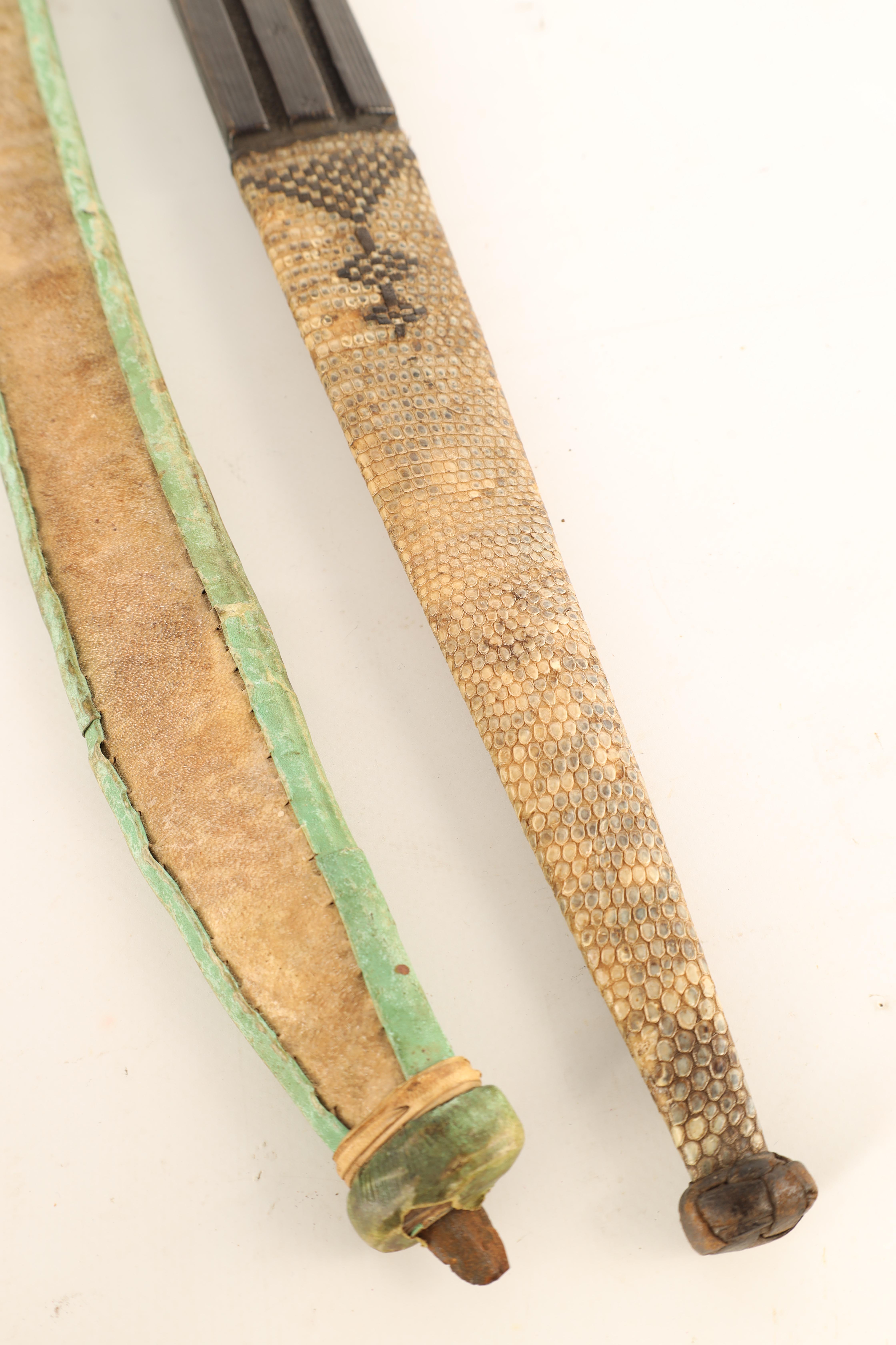 TWO 19TH CENTURY AFRICAN DAGGERS one with a snakeskin handle and scabbard having a tapering steel - Image 6 of 7