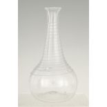 AN 18TH CENTURY CLEAR GLASS DECANTER with entwined spiral decoration 24cm high