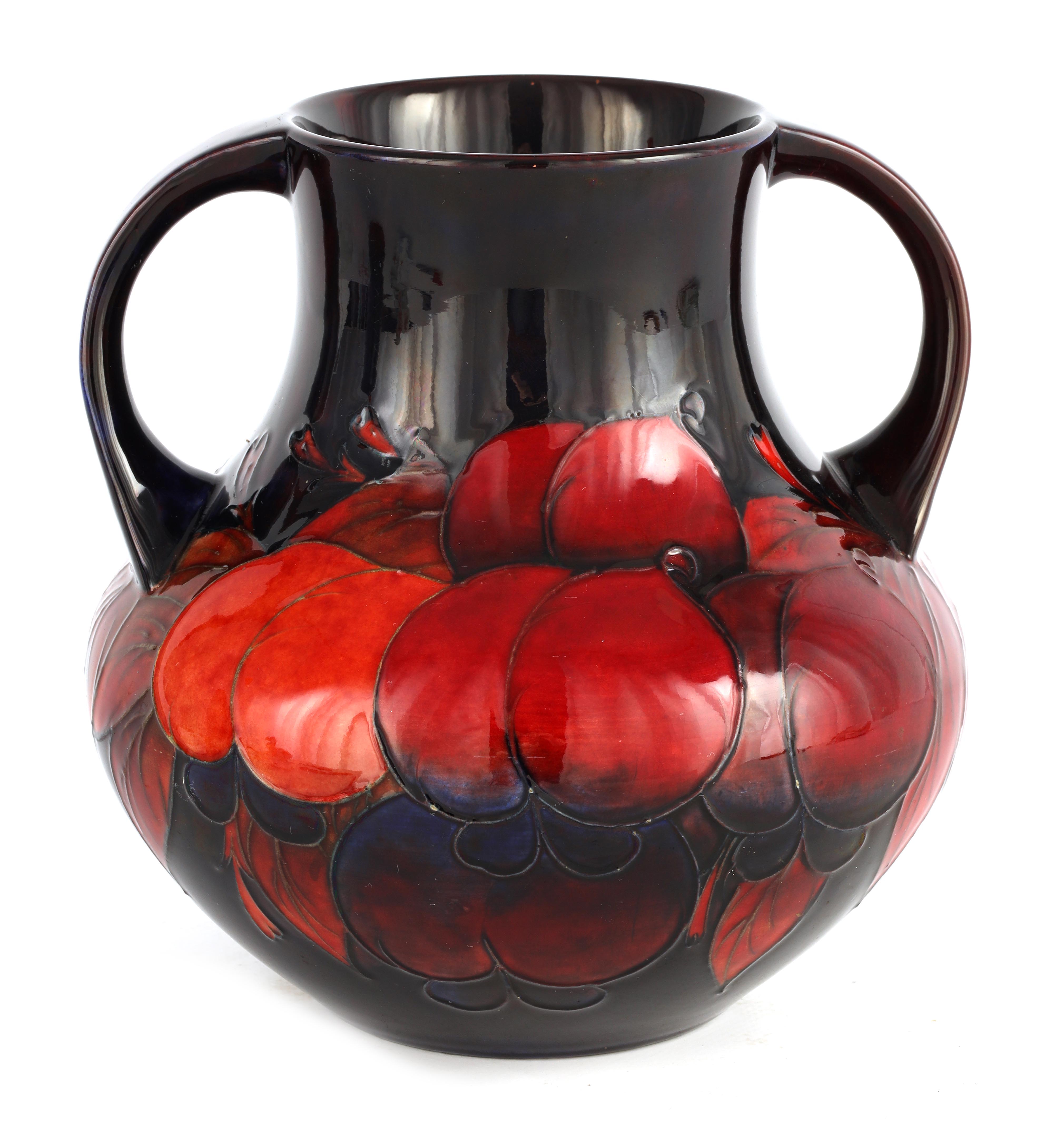 A 1930S/40S MOORCROFT LARGE TWO HANDLED BULBOUS VASE richly decorated all round in the Wisteria