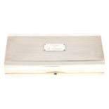 A FINE QUALITY SILVER AND TULIPWOOD CARTIER CIGAR BOX of rectangular form, rounded to the front