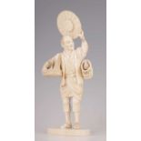 A 19TH CENTURY JAPANESE CARVED IVORY FIGURE OF A BIRD CATCHER