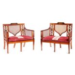A PAIR OF 19TH CENTURY PAINTED SATINWOOD SHERATON STYLE TWO SEATER SETTEES