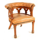 A 19TH CENTURY OAK GOTHIC STYLE UPHOLSTERED LEATHER DESK CHAIR IN THE MANNER OF PUGIN