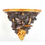A 19TH CENTURY CONTINENTAL CARVED STAINED WOOD AND GILT HANGING BRACKET