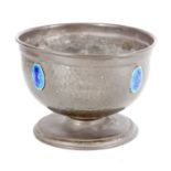 AN ARTS AND CRAFTS PLANISHED PEWTER BOWL SET WITH RUSKIN STYLE BLUE ENAMEL MEDALLIONS
