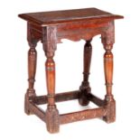 A 19TH CENTURY CARVED OAK JOINT STOOL