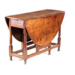 A GEORGE III OAK GATE LEG TABLE