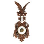 A LARGE 19TH CENTURY BLACK FOREST CARVED BAROMETER