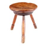 AN EARLY 18TH CENTURY ELM AND ASH STOOL