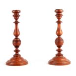 A PAIR OF 19TH CENTURY TURNED OAK CANDLESTICKS
