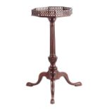 A GEORGE III FIGURED MAHOGANY KETTLE STAND