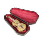 AN EARLY 20TH CENTURY CASED CONTINENTAL MINIATURE SILVER VIOLIN