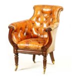A LATE REGENCY ROSEWOOD FRAMED AND STUDDED TAN LEATHER UPHOLSTERED LIBRARY CHAIR