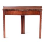 A GEORGE III FIGURED MAHOGANY SERPENTINE SHAPED CHIPPENDALE STYLE TEA TABLE