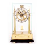 A 20TH CENTURY BRASS ELECTRIC MANTEL CLOCK UNDER GLASS CABINET