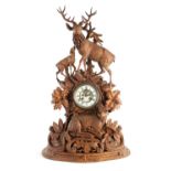 A LARGE LATE 19TH CENTURY CARVED BLACK FOREST MANTEL CLOCK