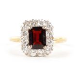 A LADIES 18CT GOLD AND PLATINUM GARNET AND DIAMOND RING