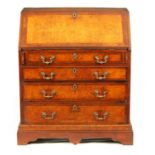 AN EARLY 18TH CENTURY BURR ELM AND WALNUT CROSSBANDED BUREAU