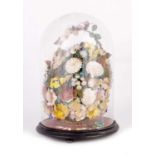 A 19TH CENTURY DOME SHAPED GLASS DOME WITH SHELL FLOWER DISPLAY