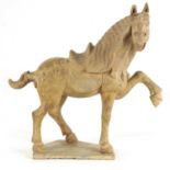 A CHINESE EARTHENWARE MODEL OF A TANG HORSE