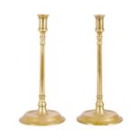 A PAIR OF LATE GEORGIAN BRASS CANDLESTICKS