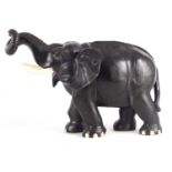 A LARGE LATE 19TH CENTURY ANGLO-INDIAN CARVED EBONY ELEPHANT