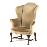 A GEORGE II MAHOGANY WINGBACK UPHOLSTERED ARMCHAIR