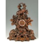 A LARGE LATE 19TH CENTURY CARVED BLACK FOREST MANTEL CLOCK