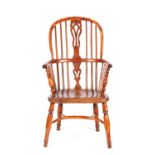 AN EARLY 19TH CENTURY YEWWOOD HIGHBACK WINDSOR CHAIR