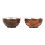 A PAIR OF 19TH CENTURY CARVED COCONUT AND SILVERED METAL BOWLS