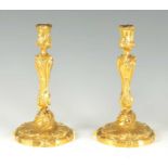 A FINE PAIR OF FRENCH ROCOCO GILT BRONZE CANDLESTICKS IN THE MANNER OF FRANCOIS LINKE