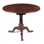 A GEORGE III FIGURED MAHOGANY TILT TOP SUPPER TABLE