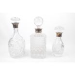 3 20thC Decanters with Silver collars with stoppers ranging from 26cm to 20cm
